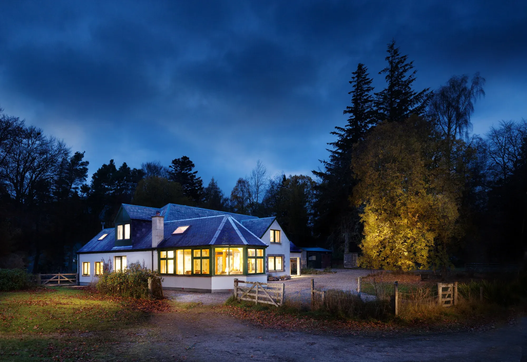 Glentruim Lodge exterior at dusk, warm lights within